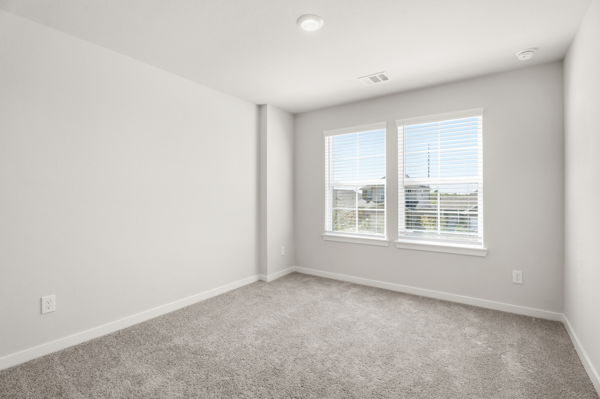 A room with a window and a carpet.