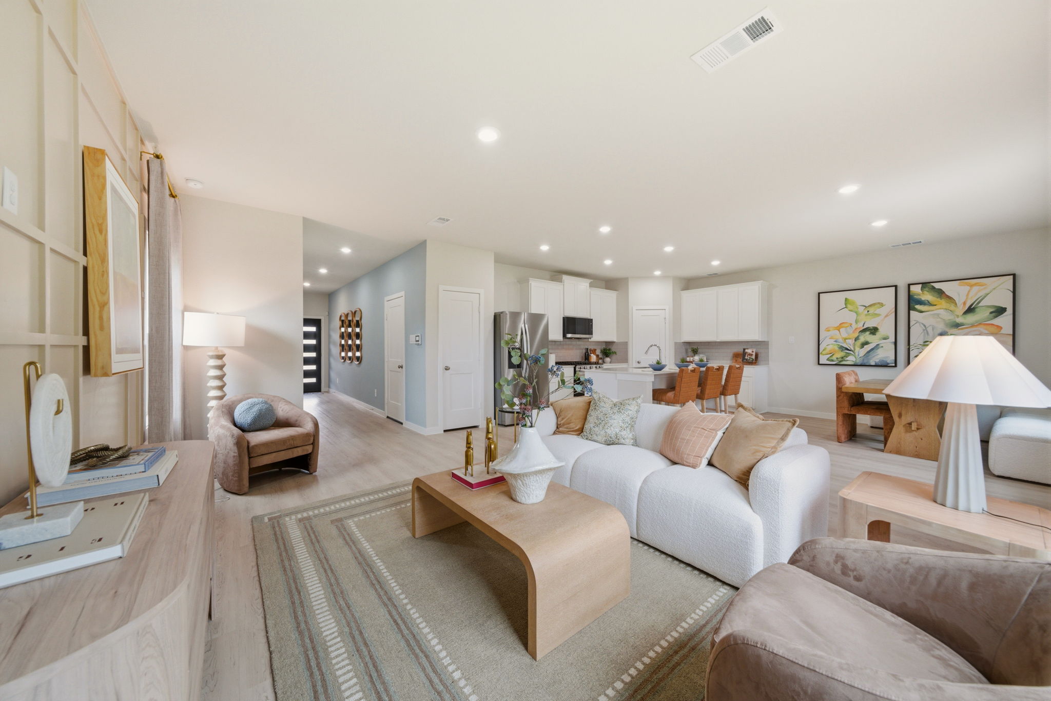 A large living room with a large rug and a couch.