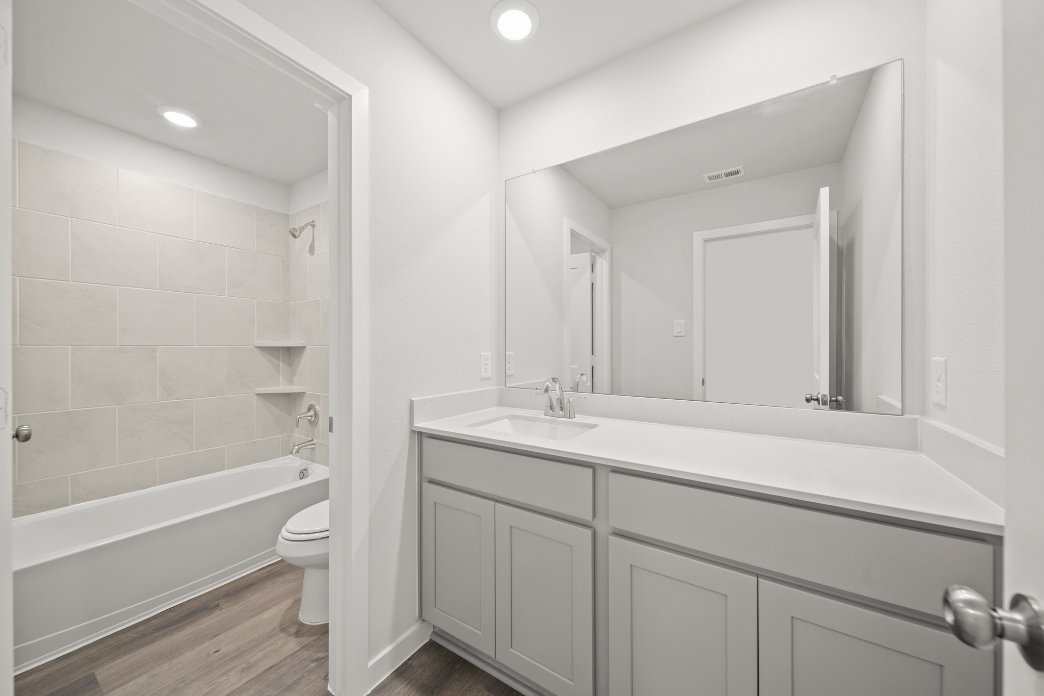 A bathroom with a tub sink and toilet.