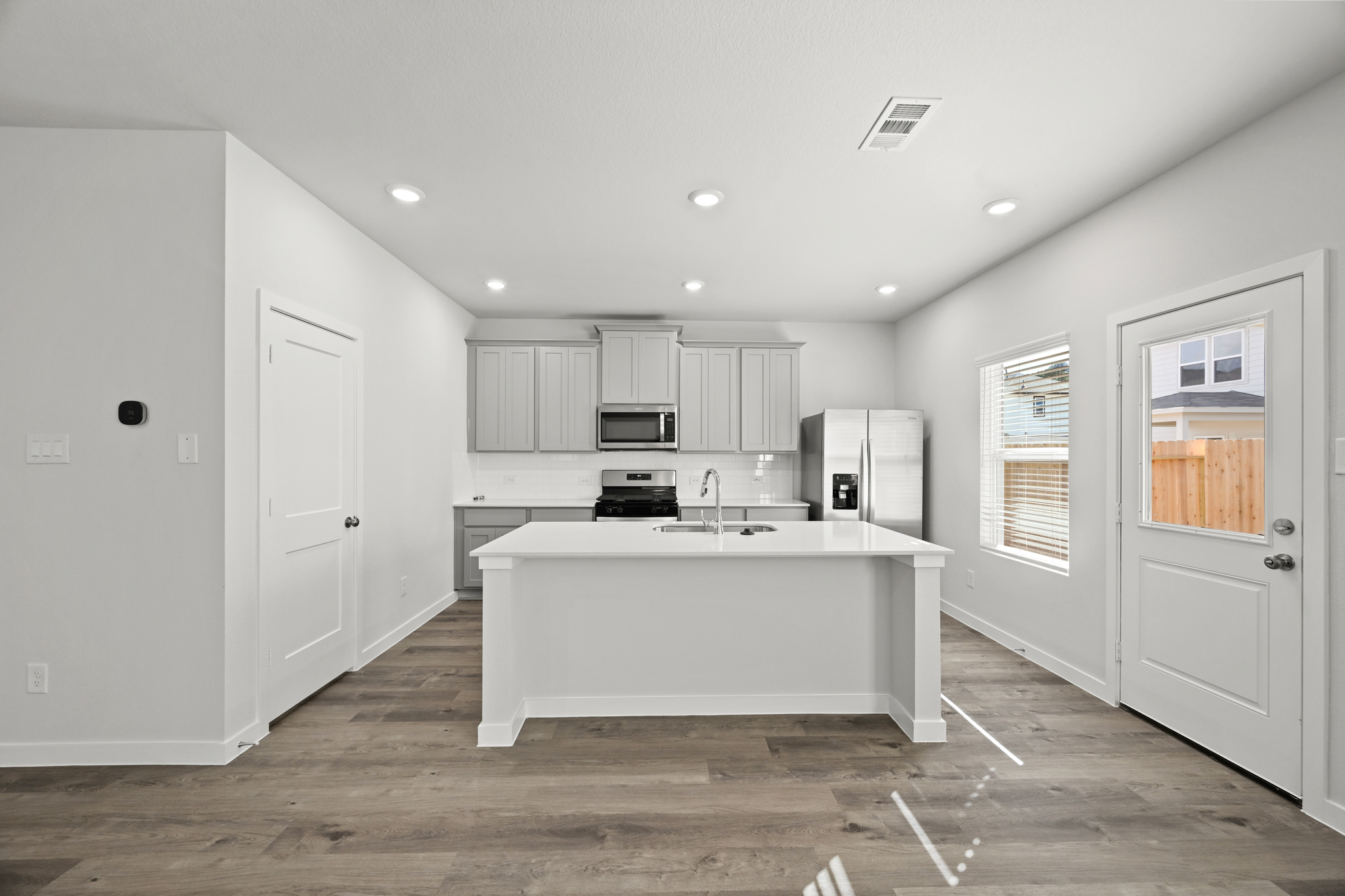 A kitchen with white cabinets.