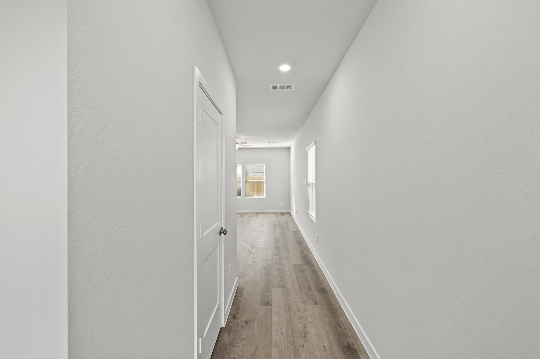 A hallway with white doors.