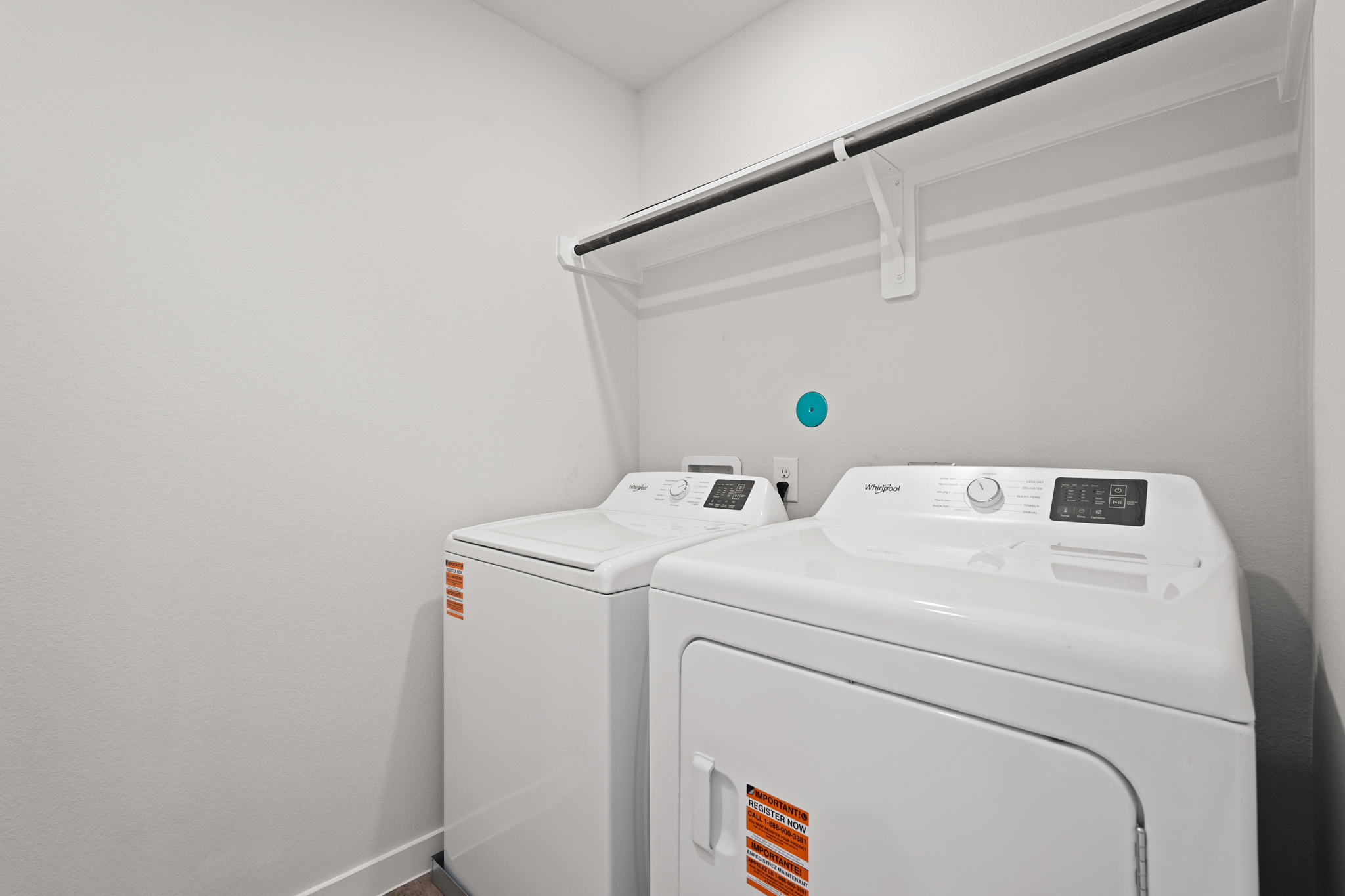 A white machine with a green light.