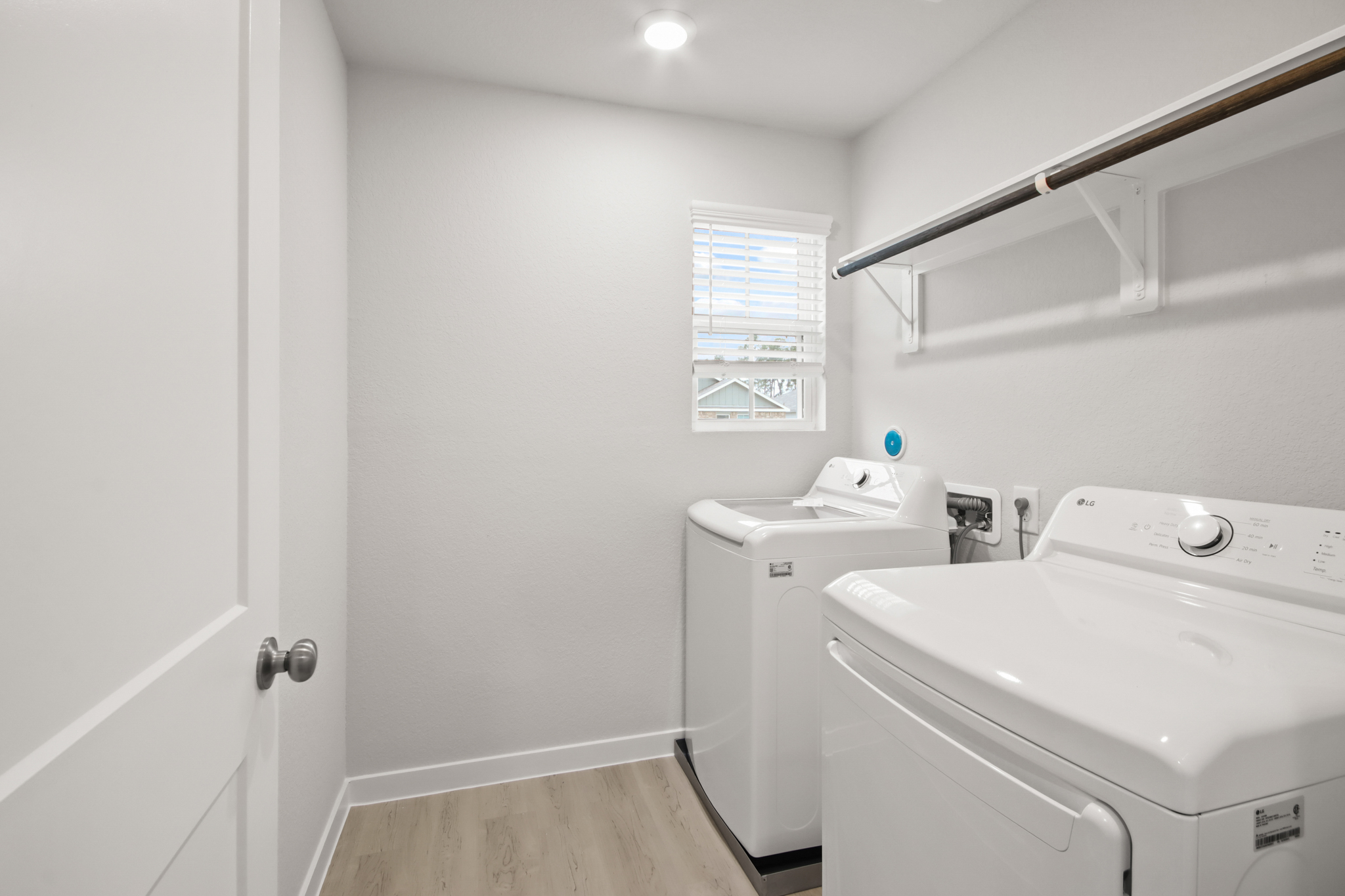 A bathroom with a washer and dryer.