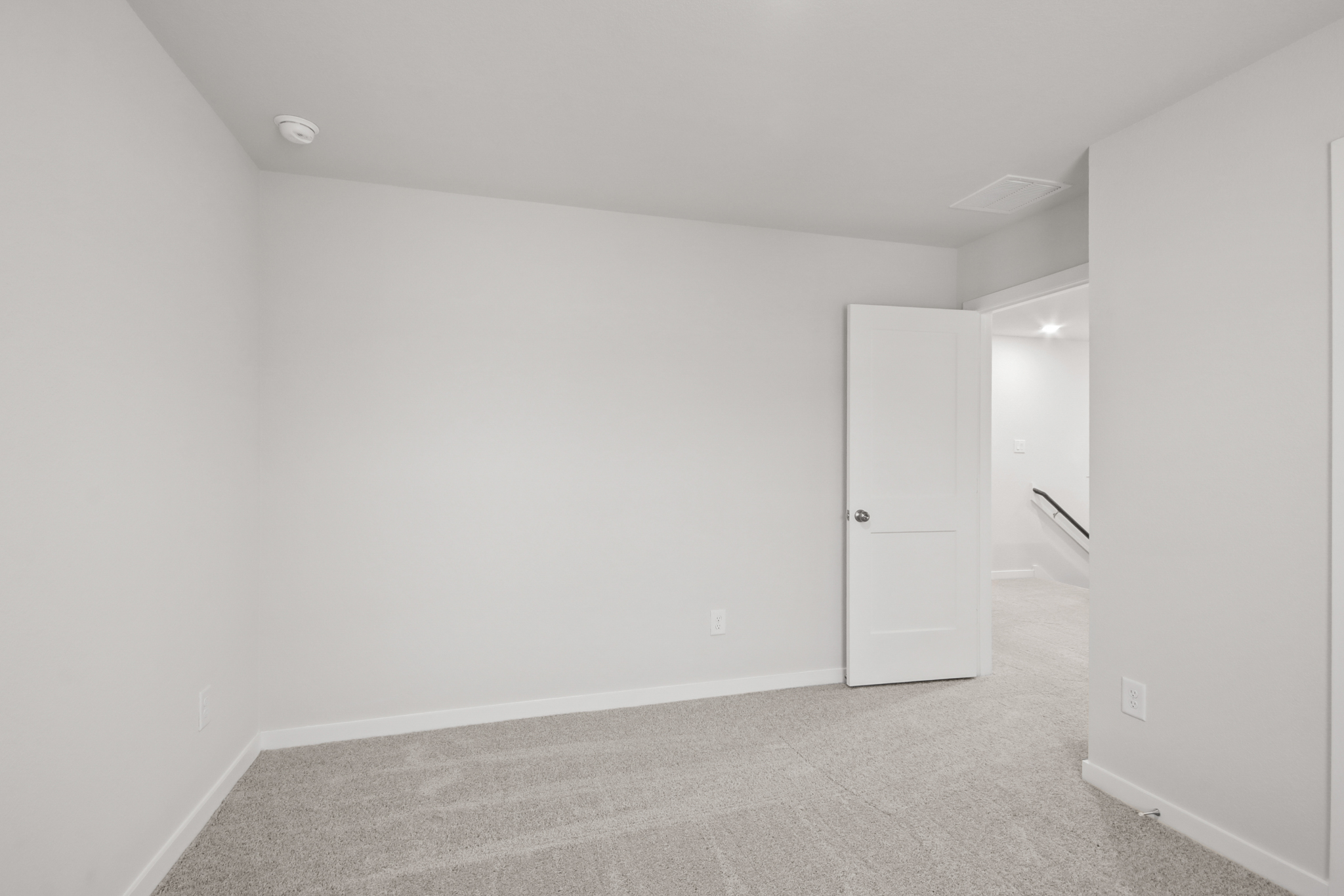 A hallway with white walls.