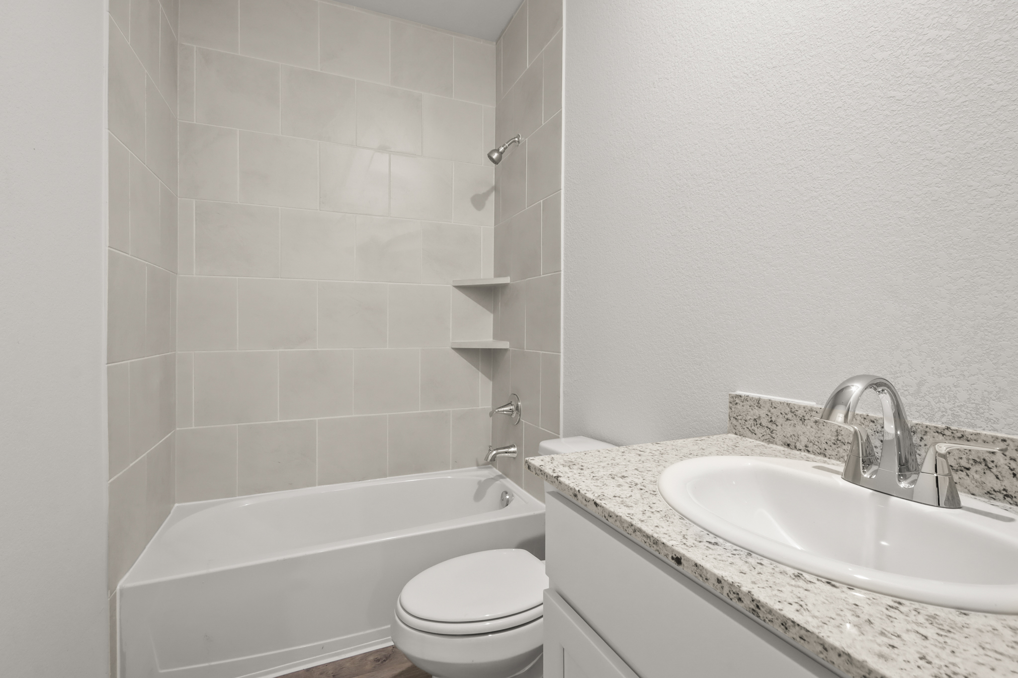 A bathroom with a tub sink and toilet.