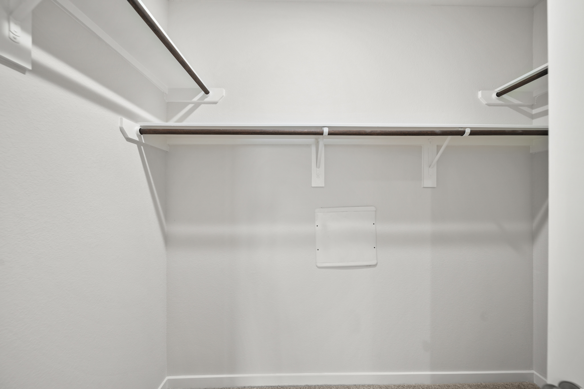 A white wall with a light fixture.