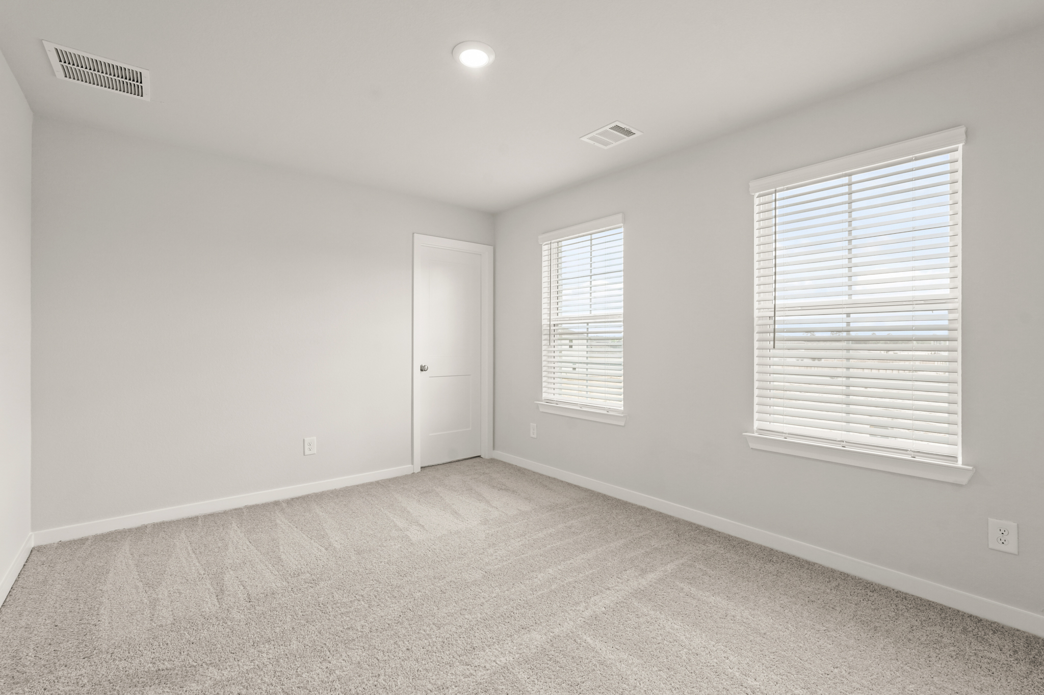 A room with a door and windows.