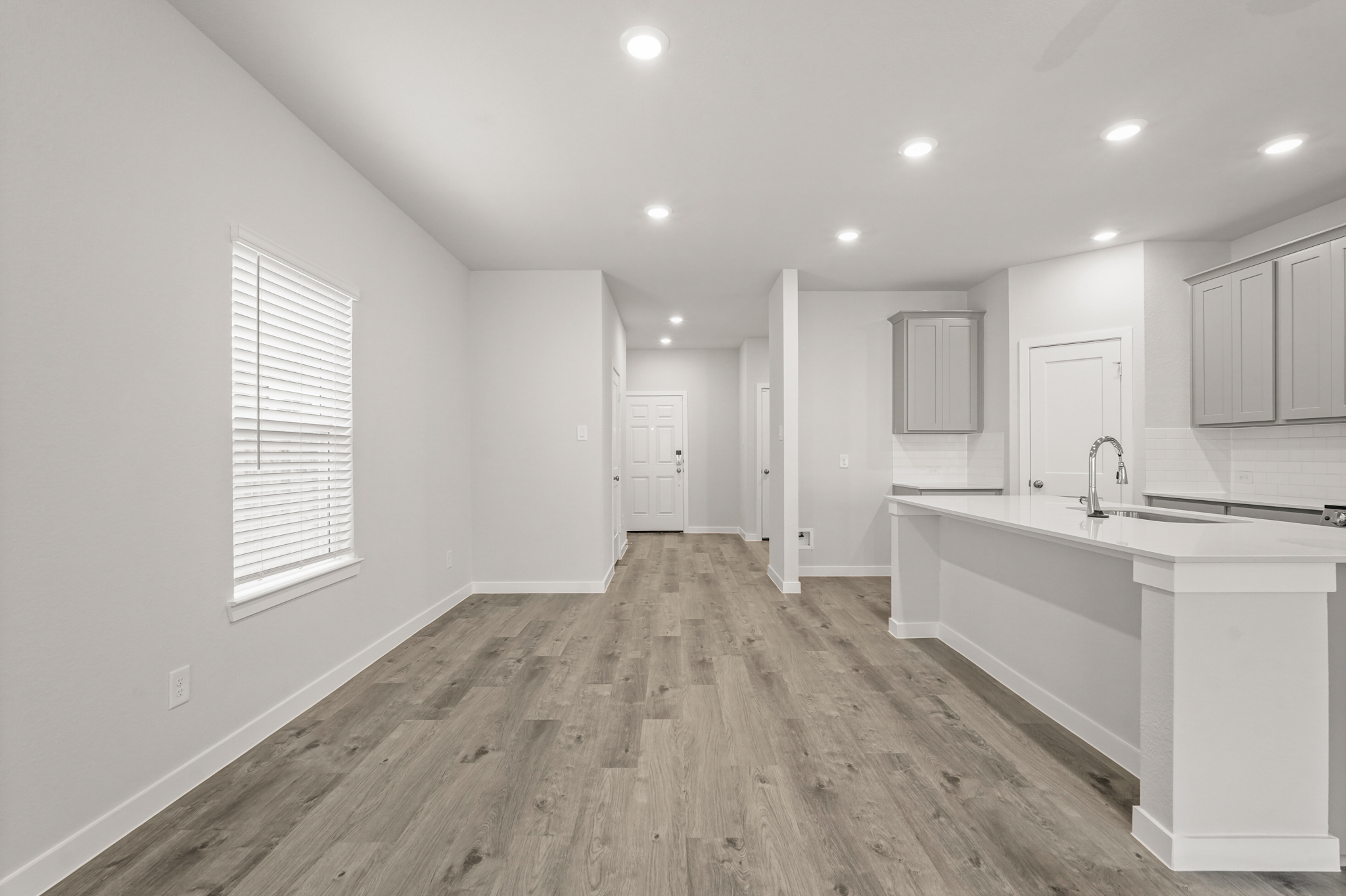 A kitchen with white cabinets.