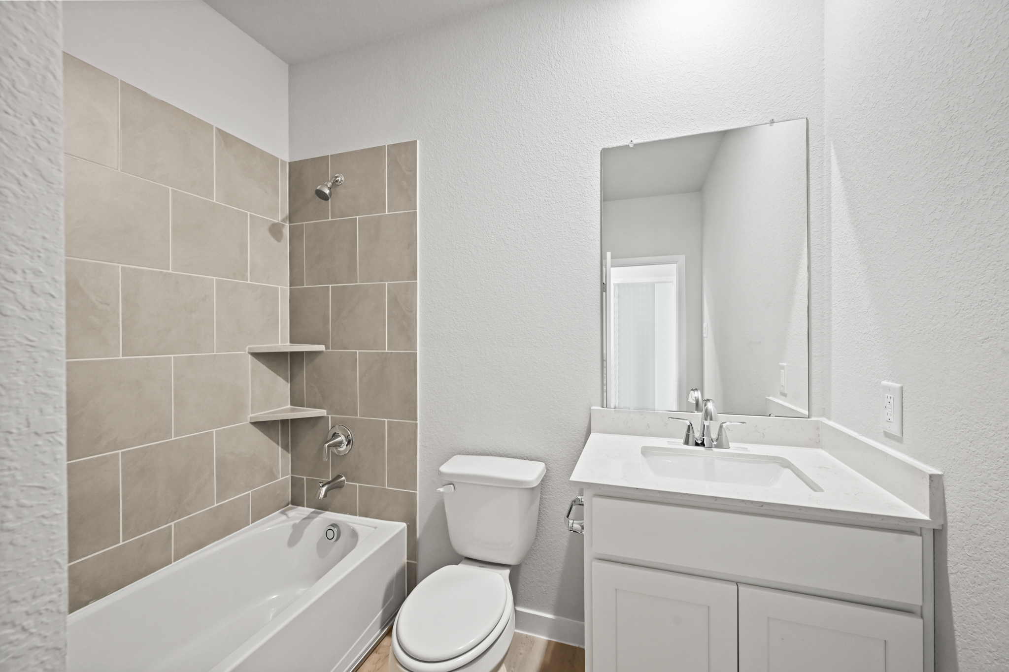 A bathroom with a tub sink and toilet.