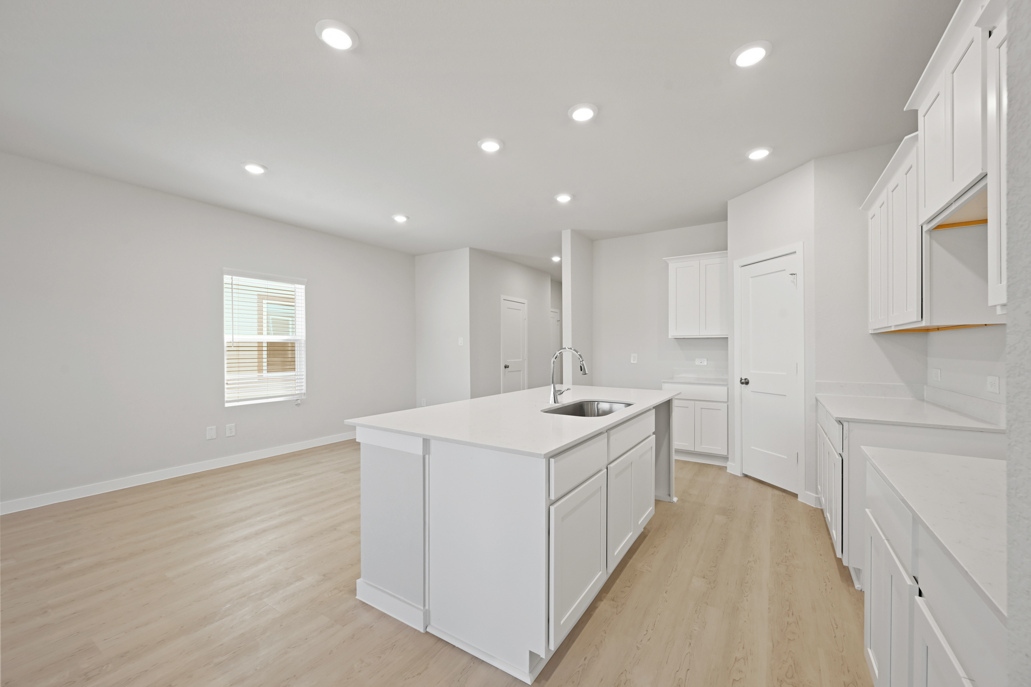 A kitchen with white cabinets.
