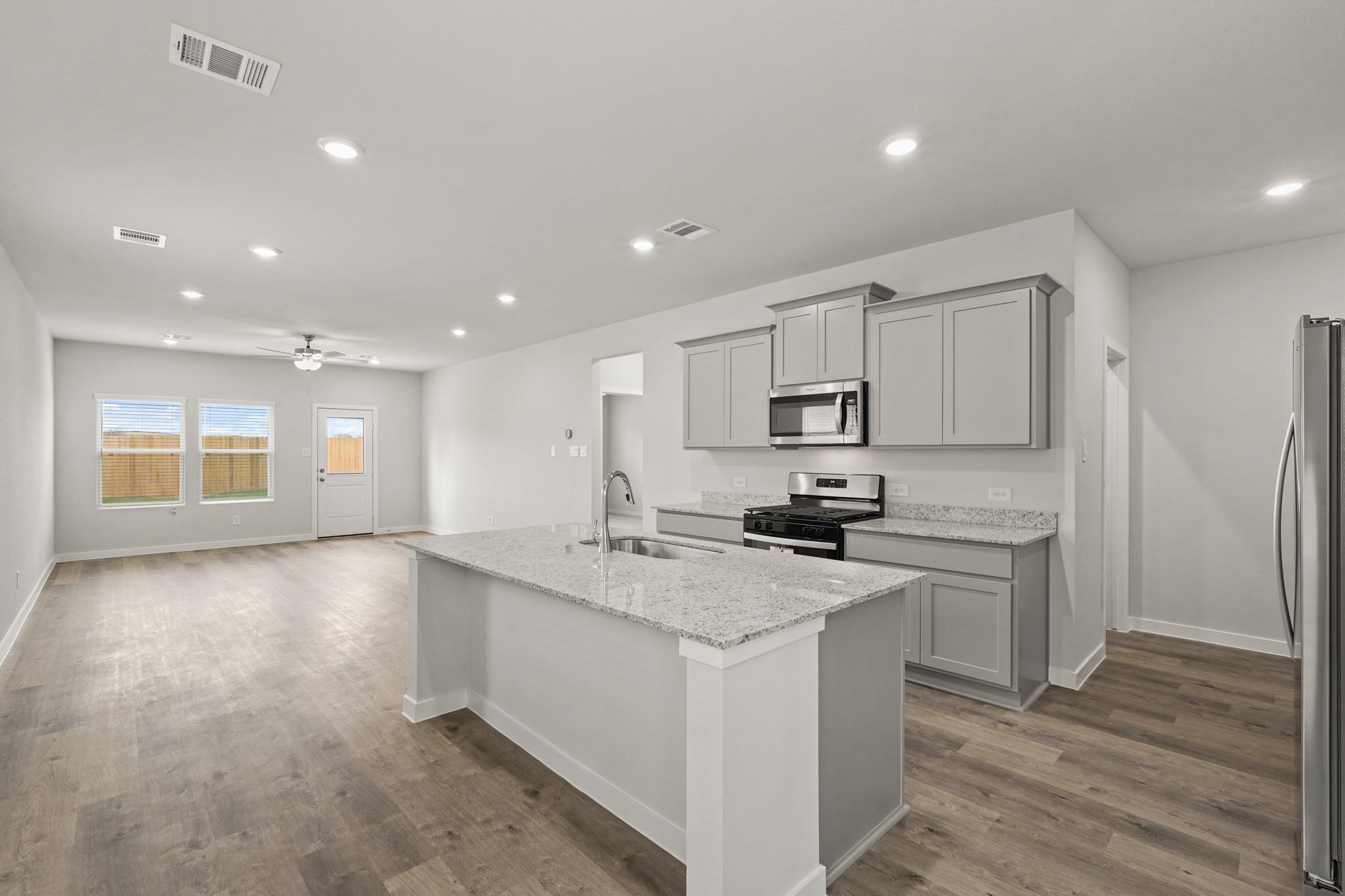 A kitchen with white cabinets.