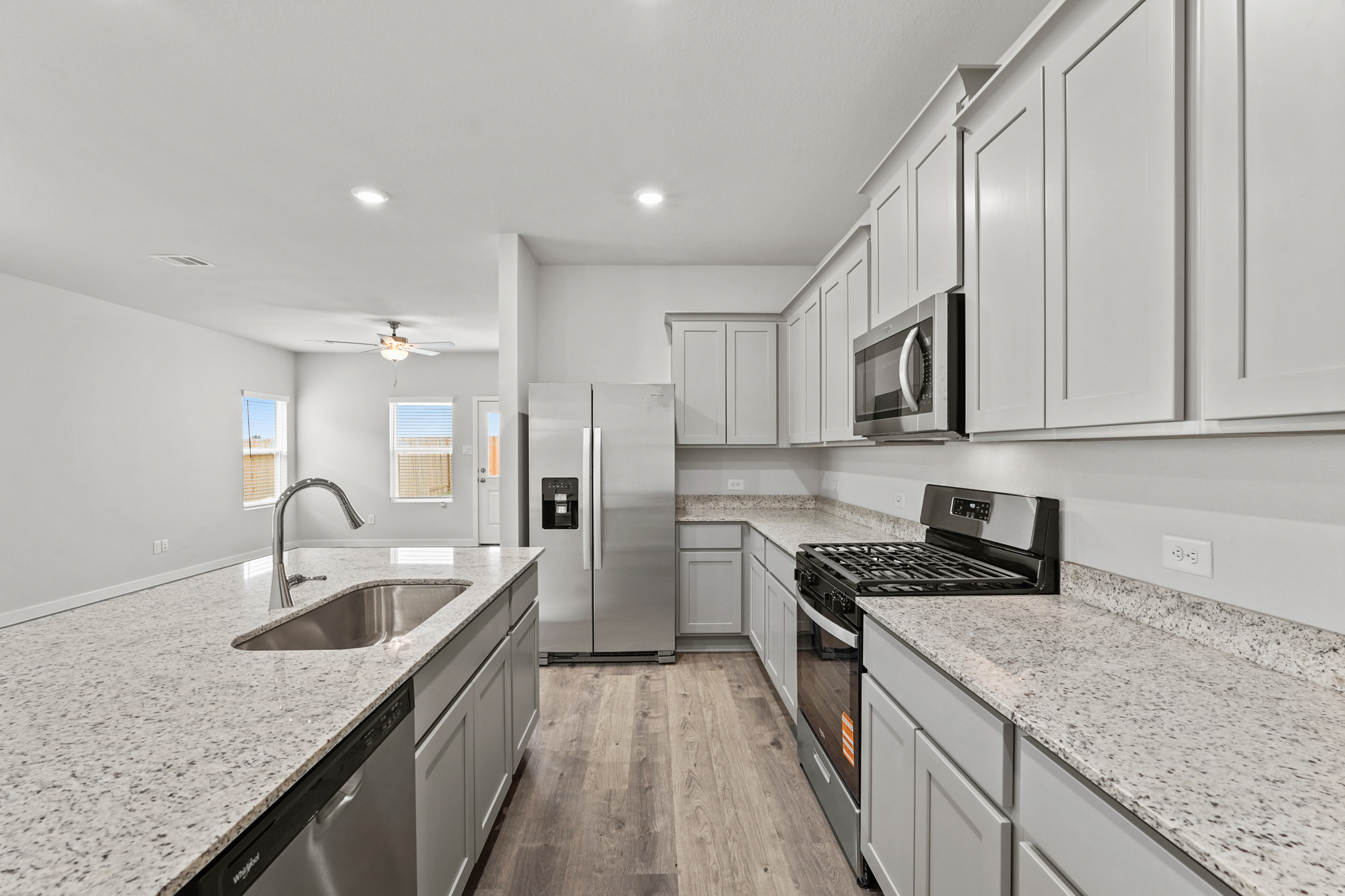 A kitchen with white cabinets.