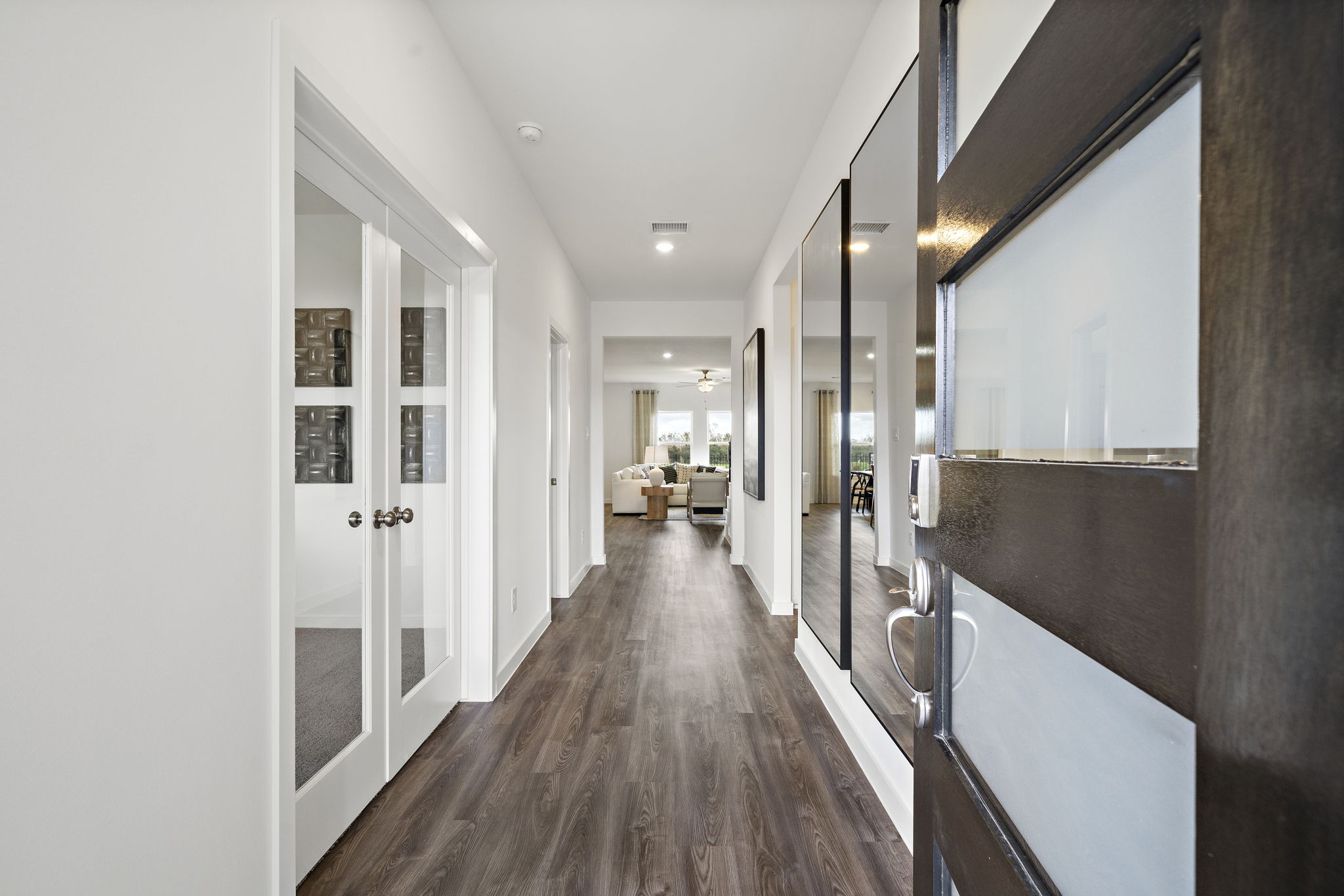 A hallway with white doors.