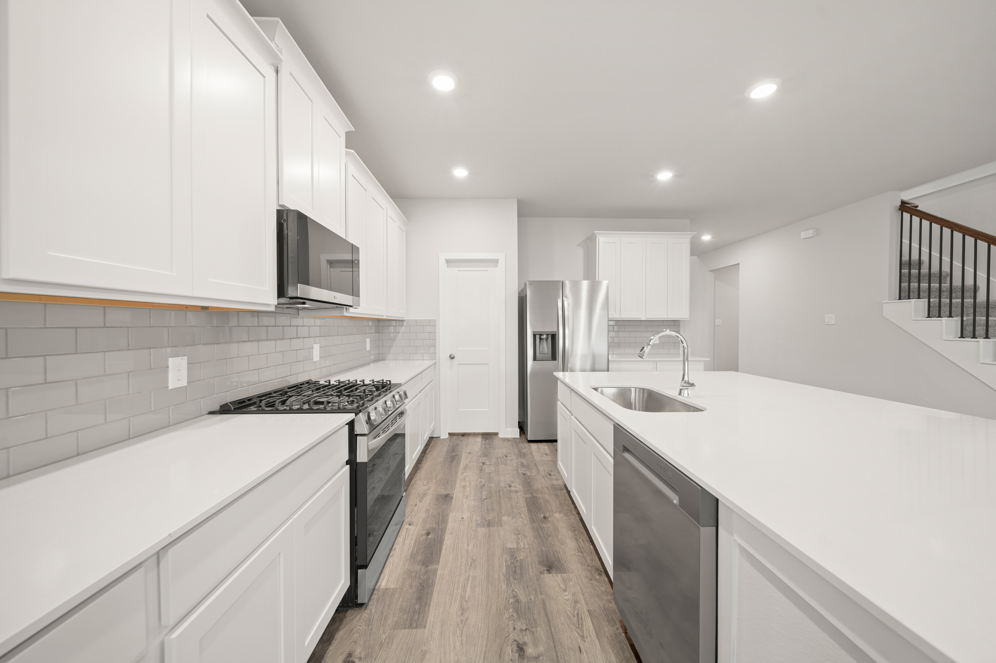 A kitchen with white cabinets.