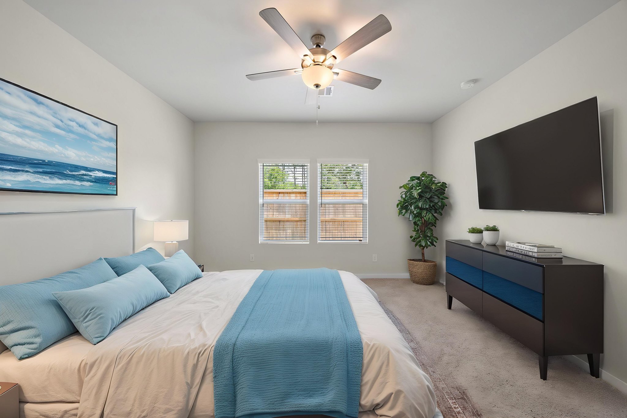 A bedroom with a bed and a fan.