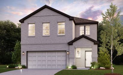 A house with a garage and trees.