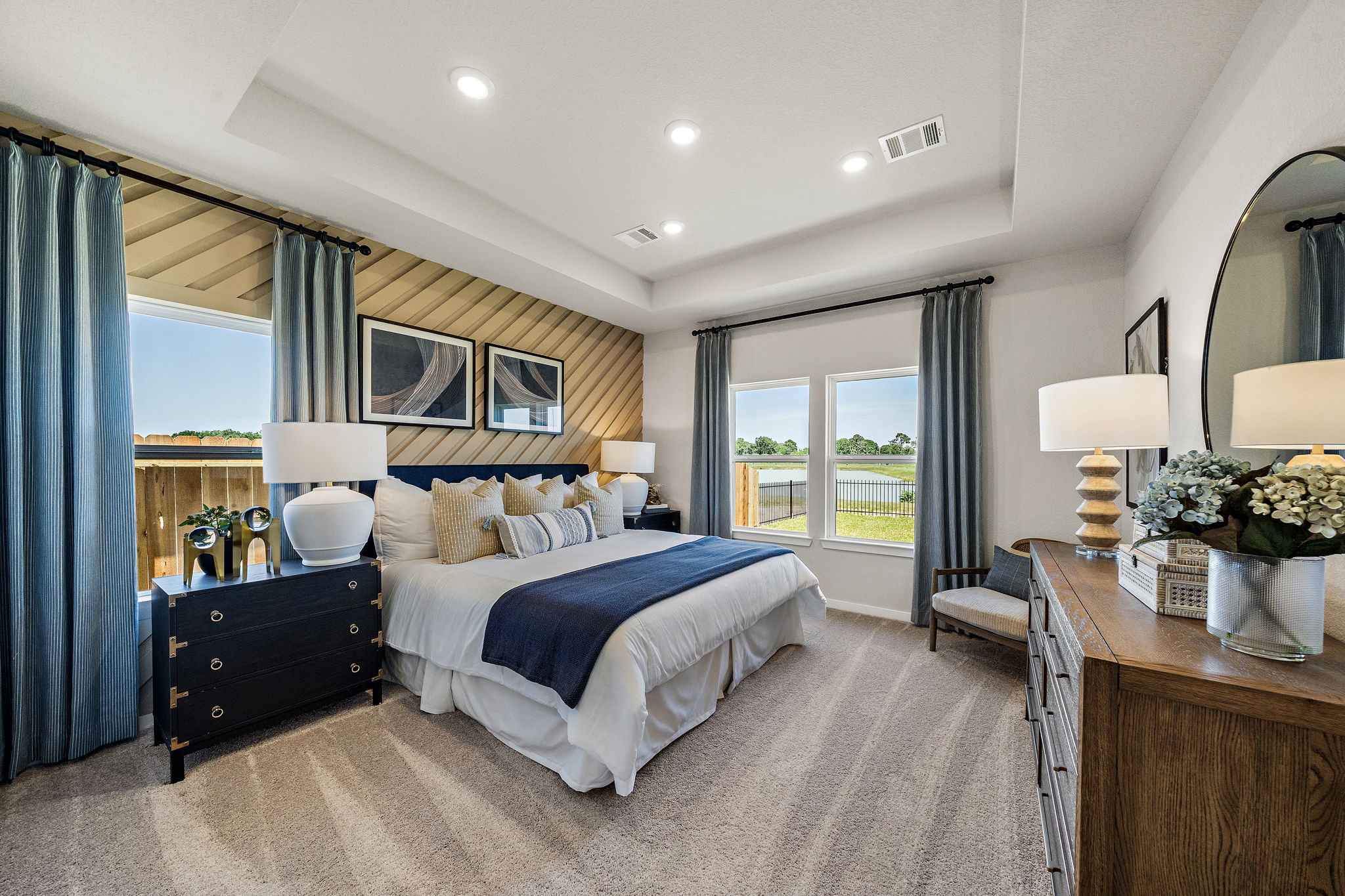 A bedroom with a large mirror.