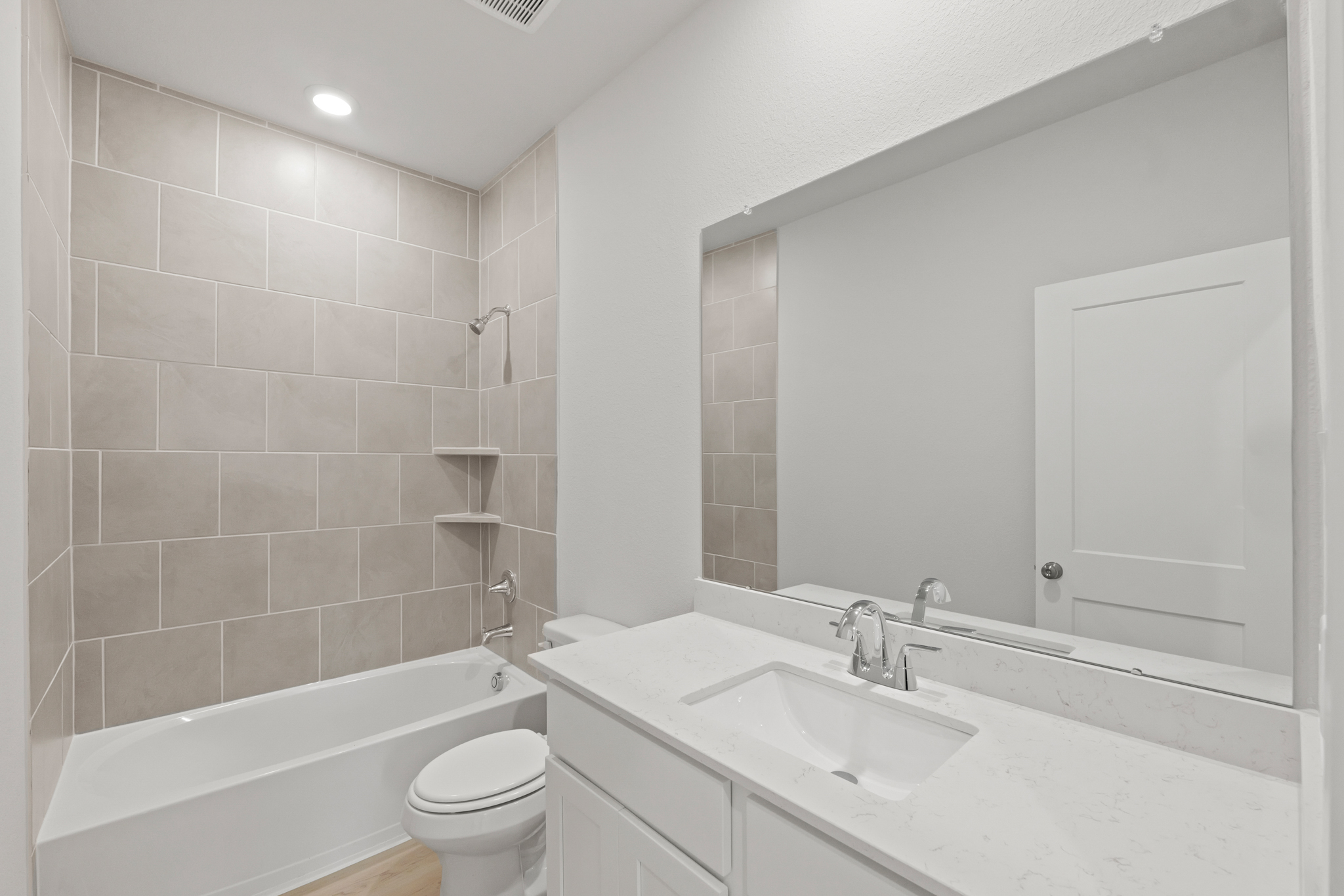 A bathroom with a tub sink and toilet.
