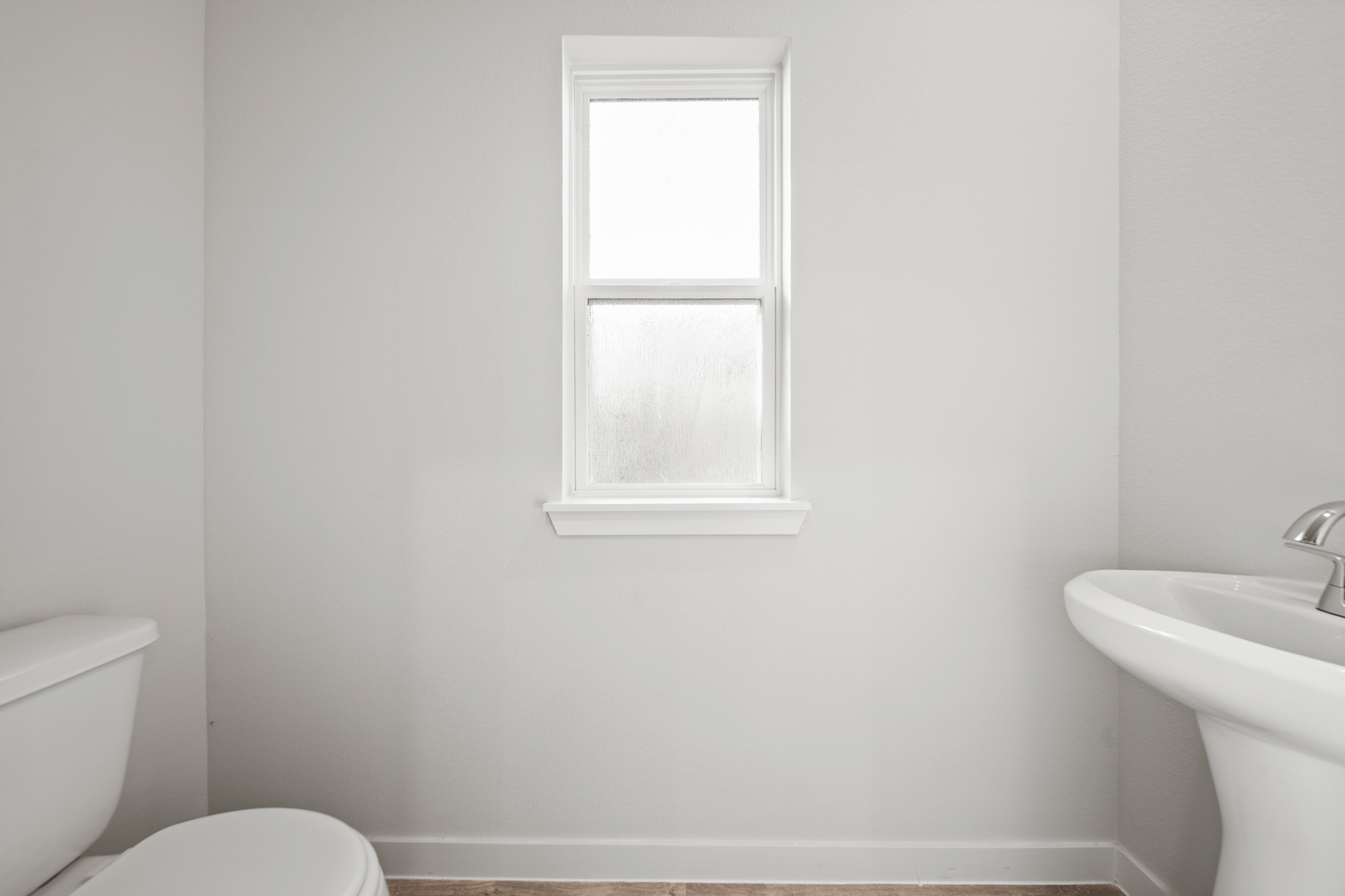 A bathroom with a sink and toilet.