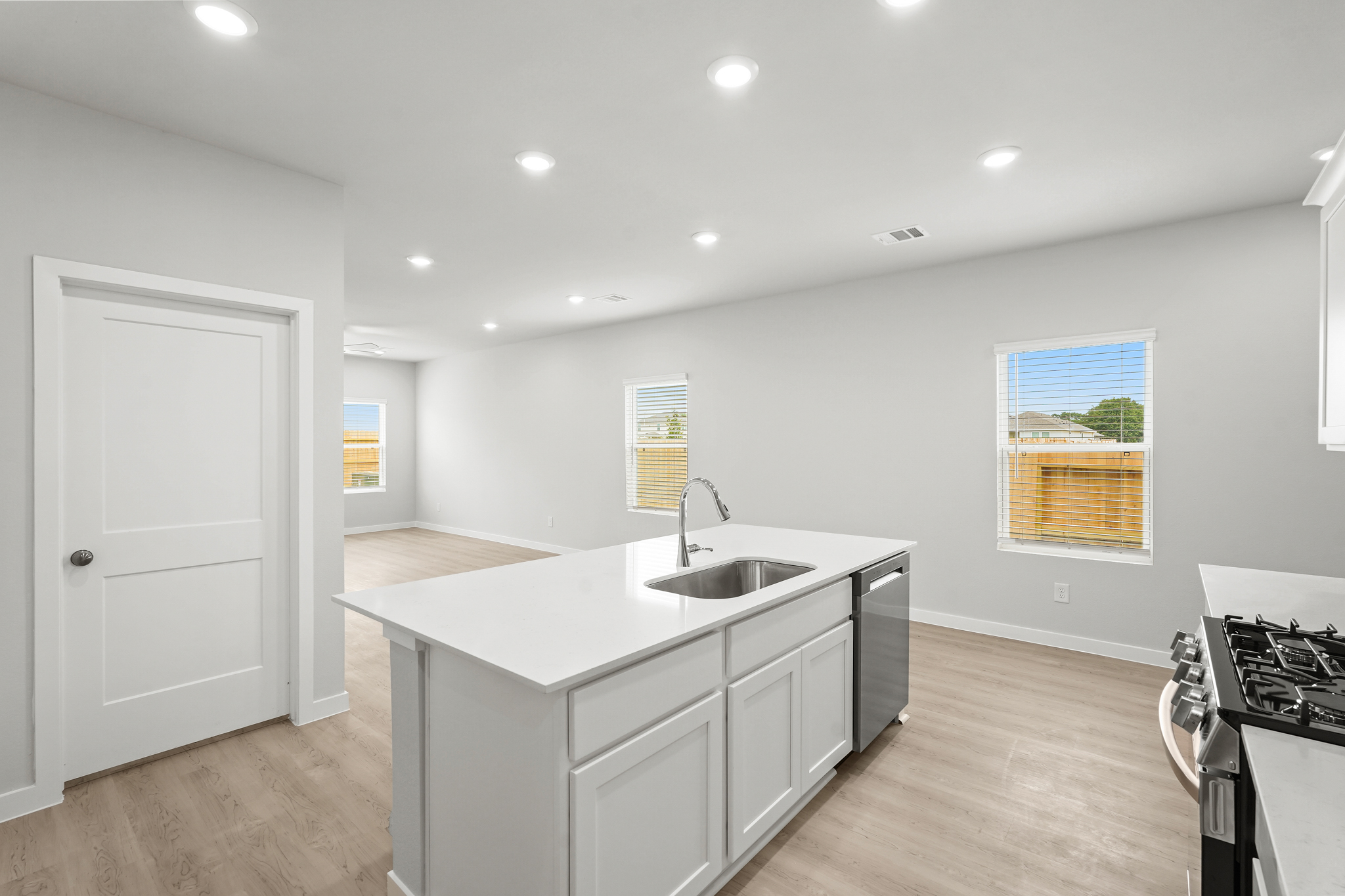 A kitchen with white cabinets.