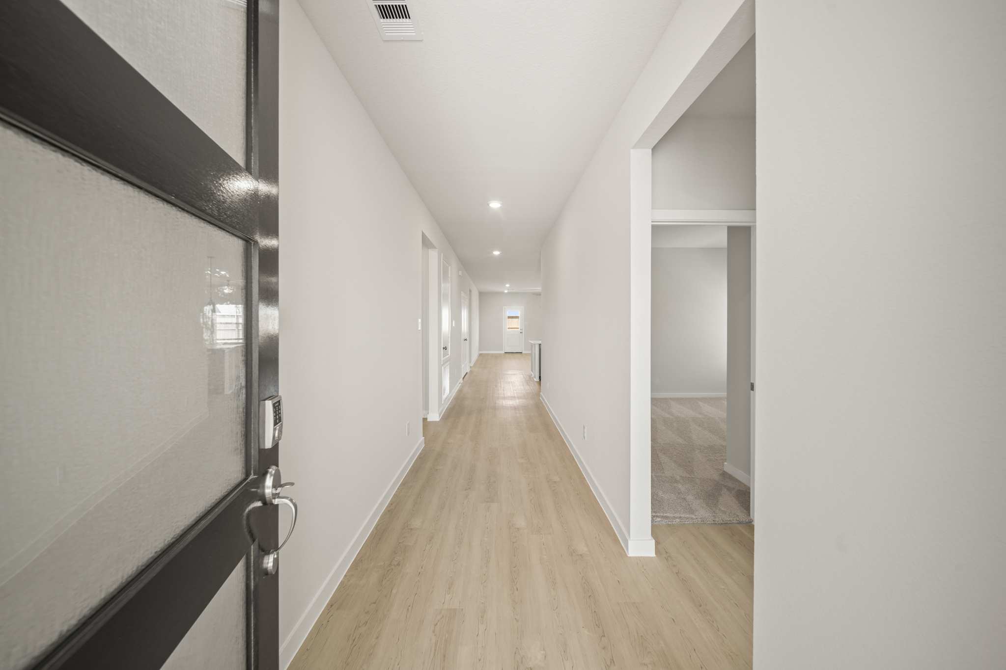 A hallway with white walls.