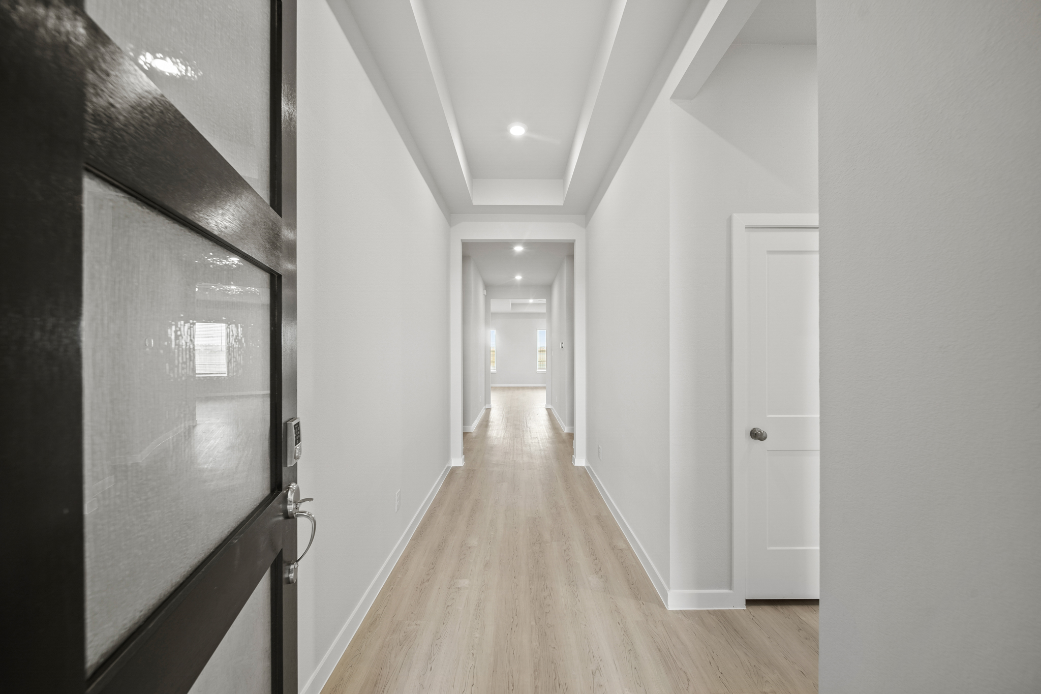 A hallway with white doors.