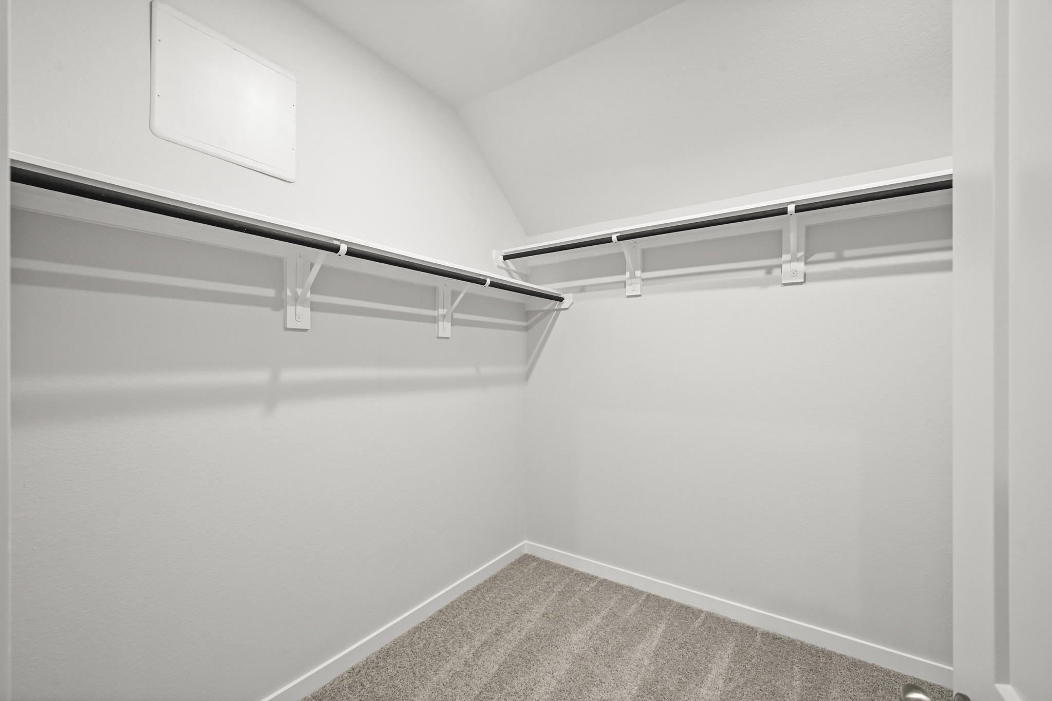 A white wall with a vent.