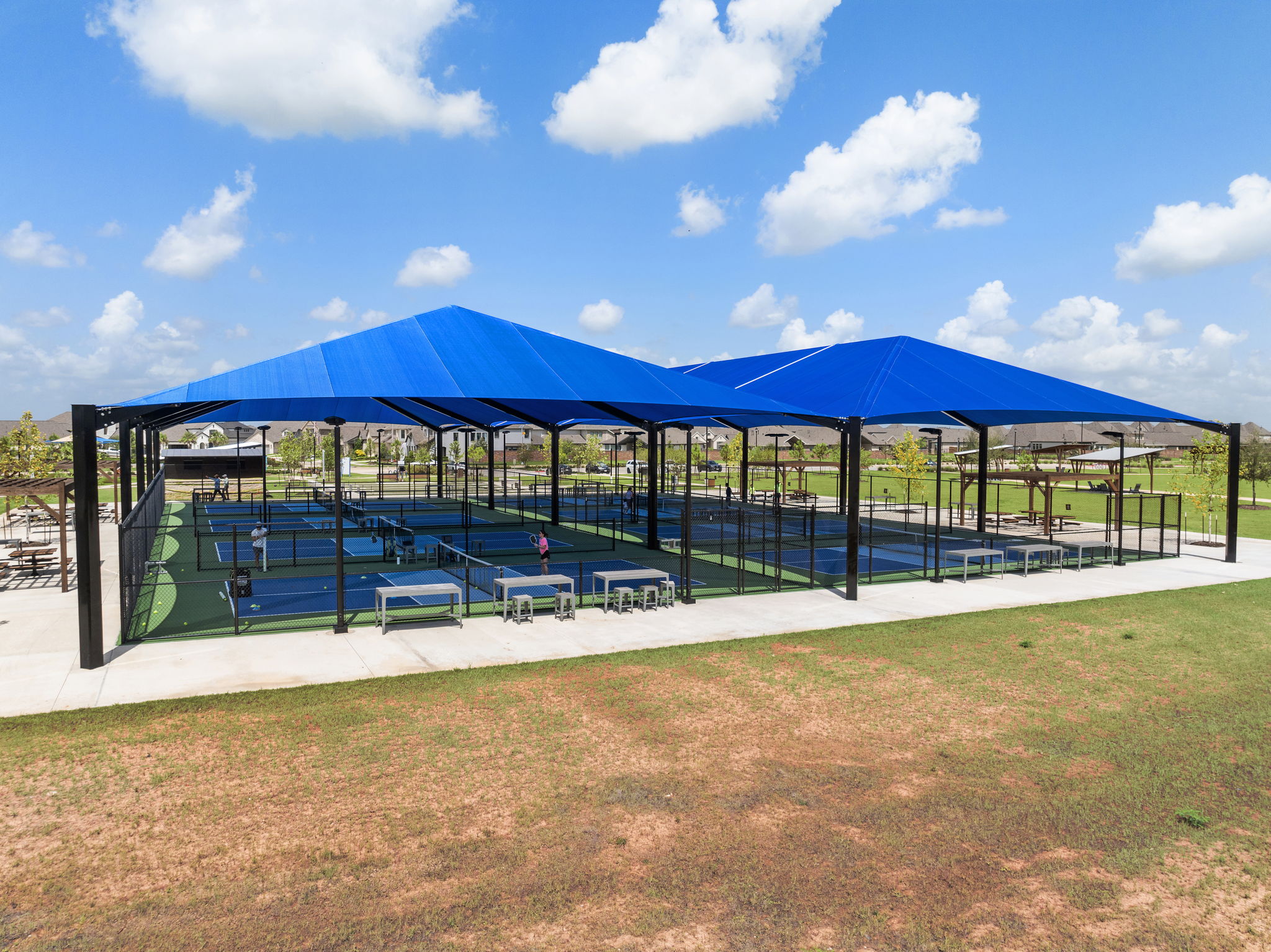 A covered area with a blue awning and a blue sky.