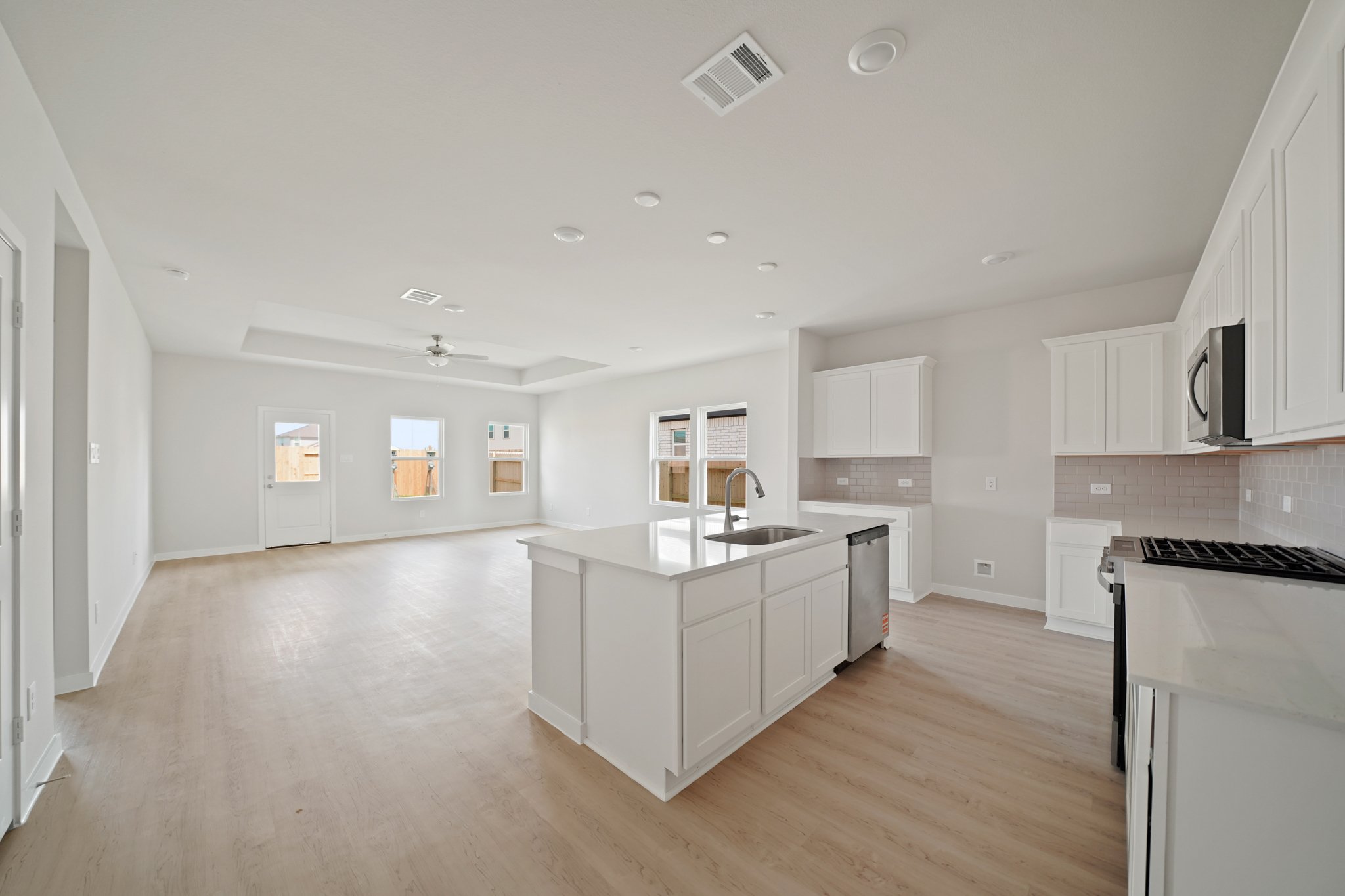 A large kitchen with white cabinets.