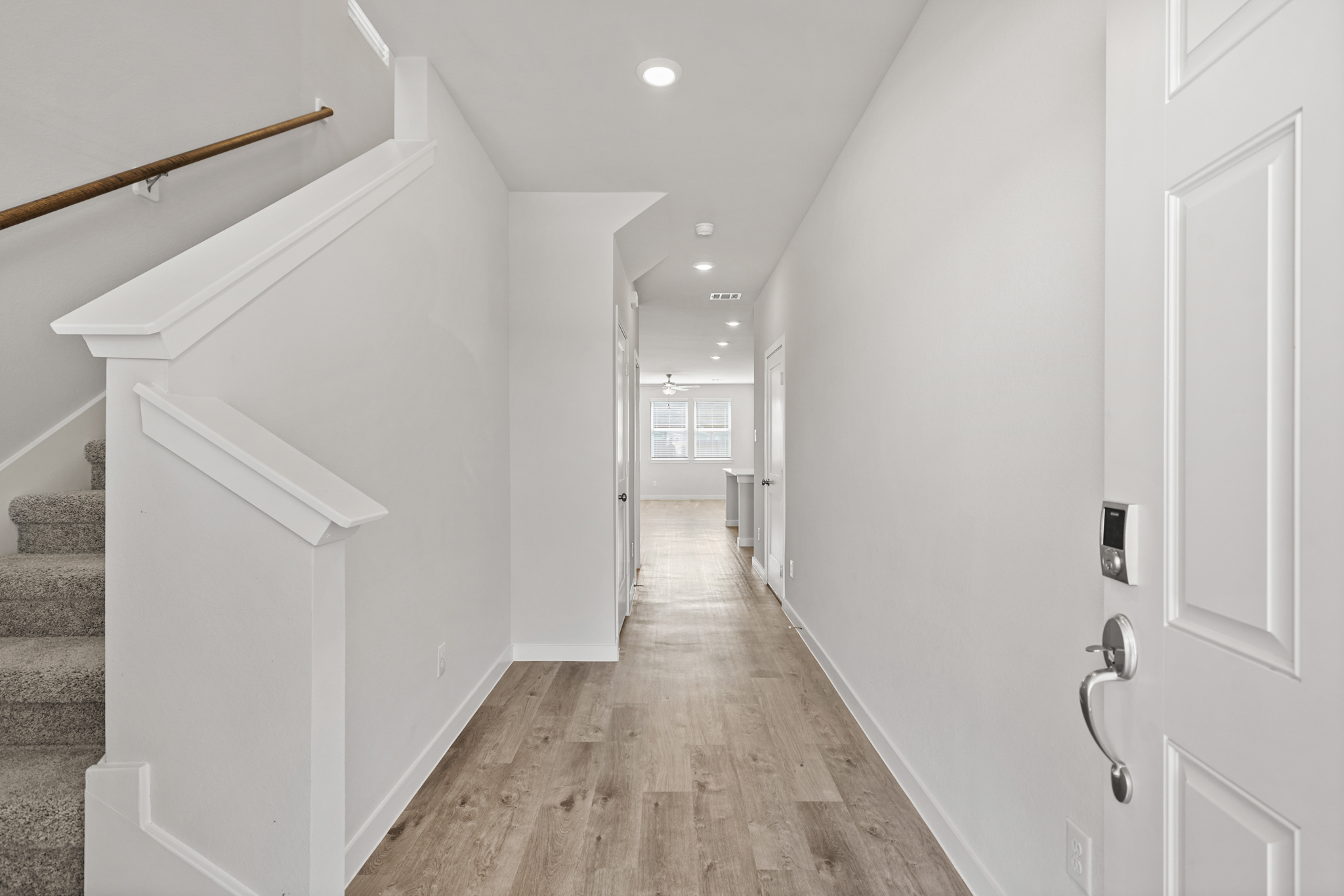 A hallway with white walls.