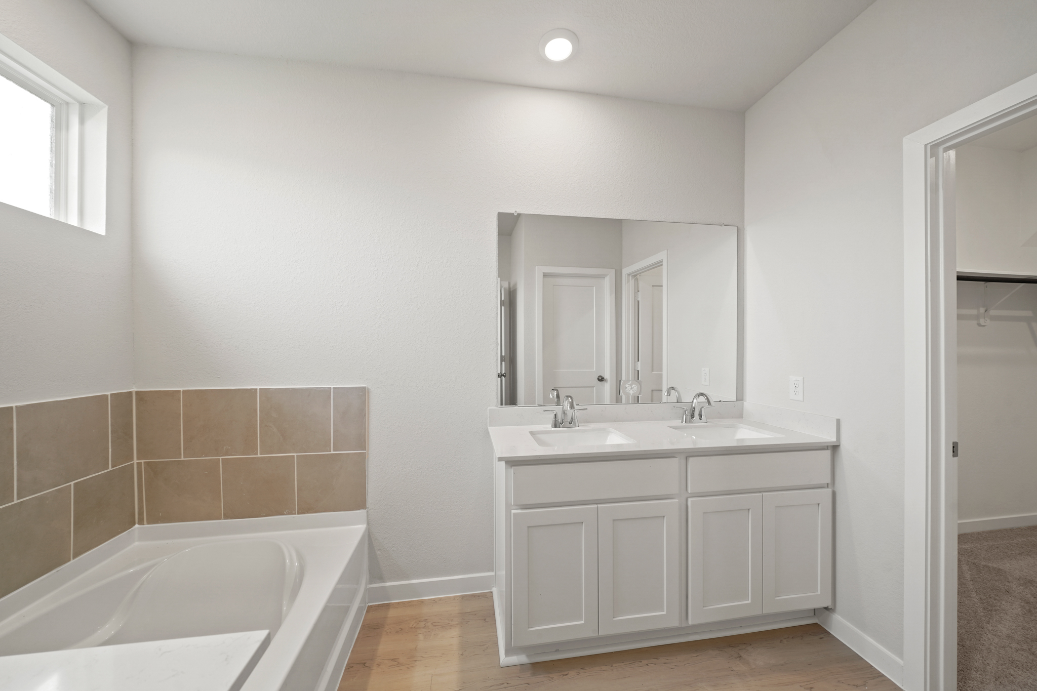 A bathroom with a tub sink and a bathtub.