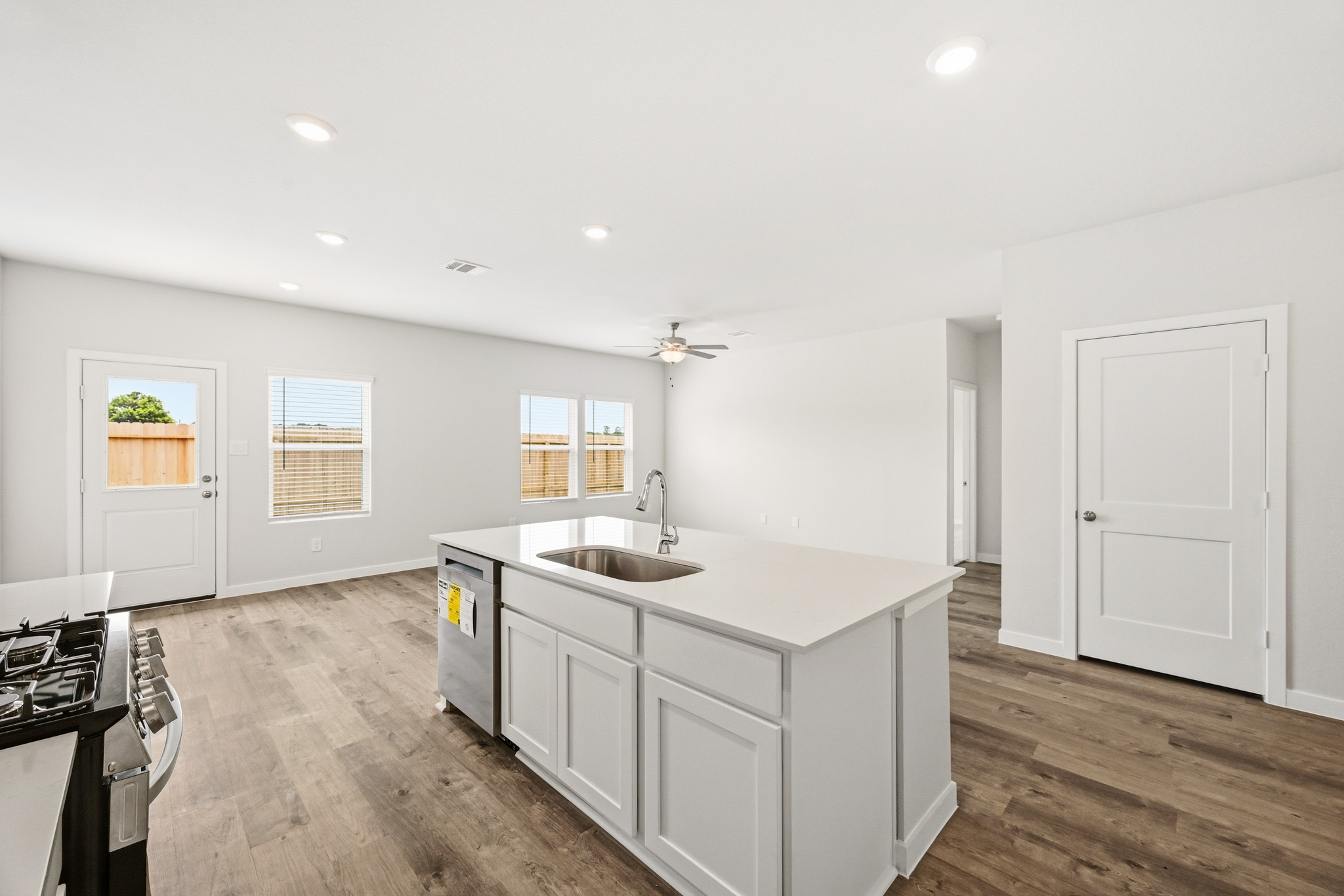 A kitchen with white cabinets.