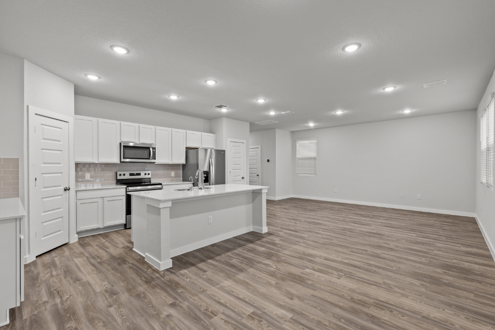 A kitchen with white cabinets.