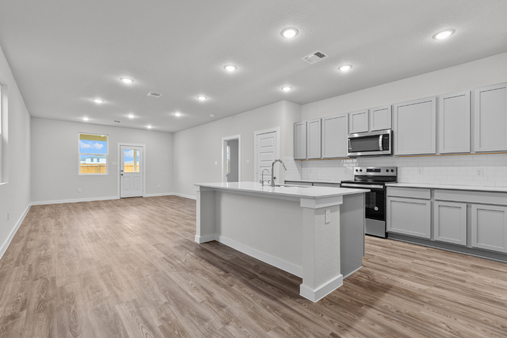 A kitchen with white cabinets.