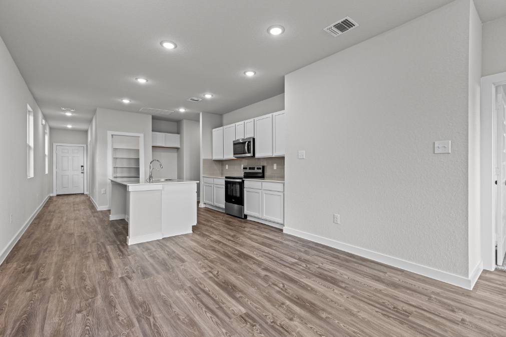 A kitchen with white cabinets.