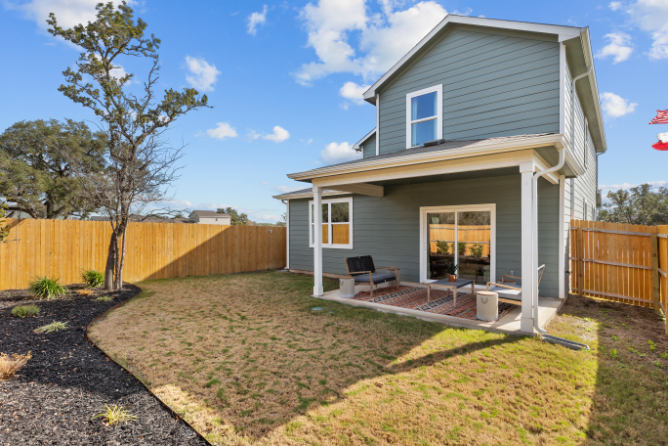 A small house with a fence.
