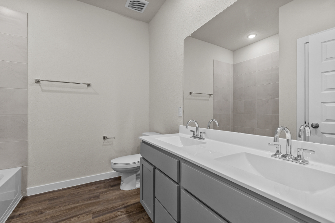 A bathroom with a large mirror.