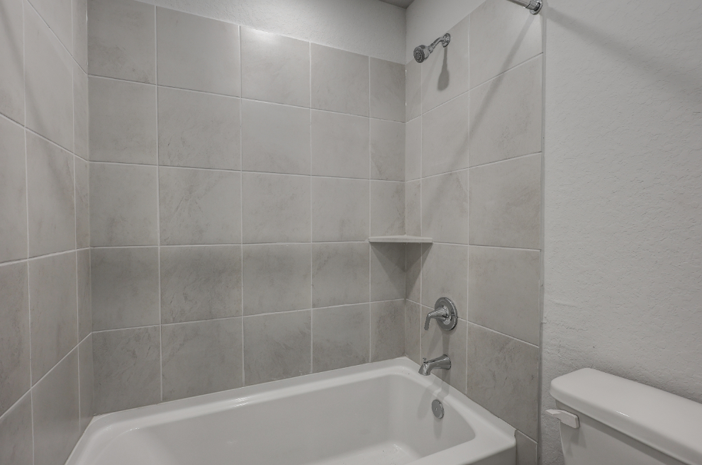 A bathroom with a bathtub and toilet.