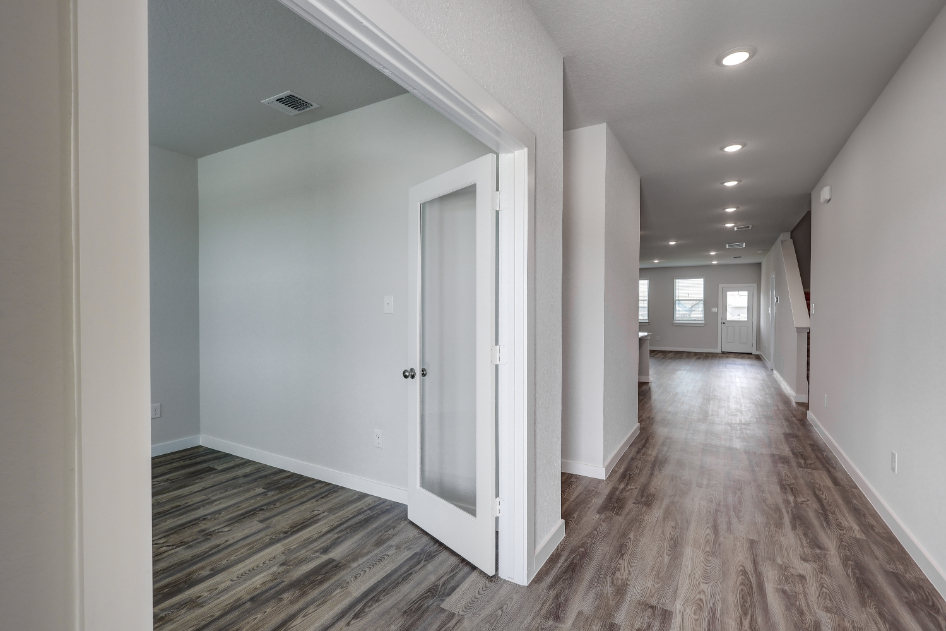 A hallway with white doors.