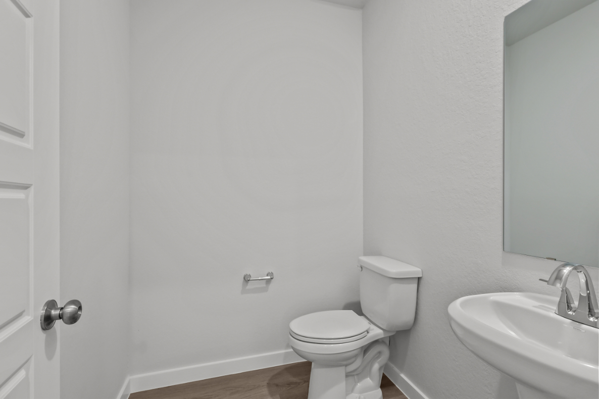 A bathroom with a toilet and sink.