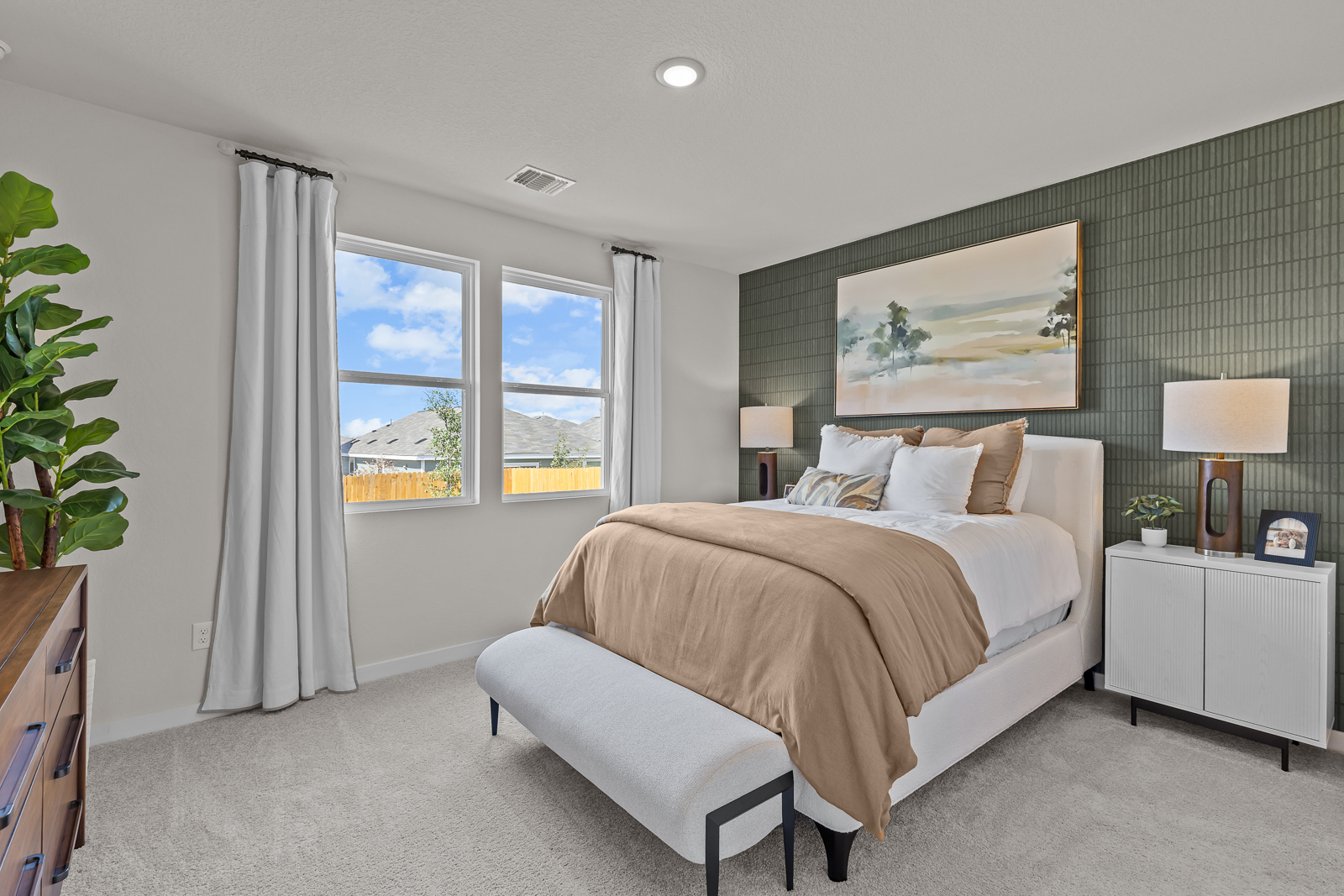 A bedroom with a large window.