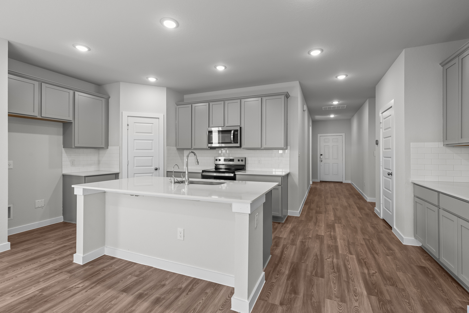 A kitchen with white cabinets.