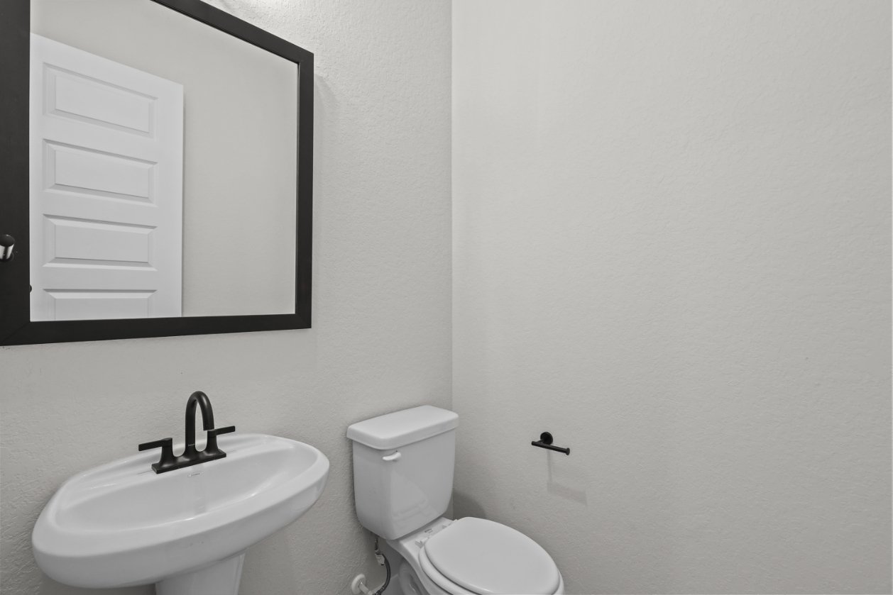 A bathroom with a sink and toilet.