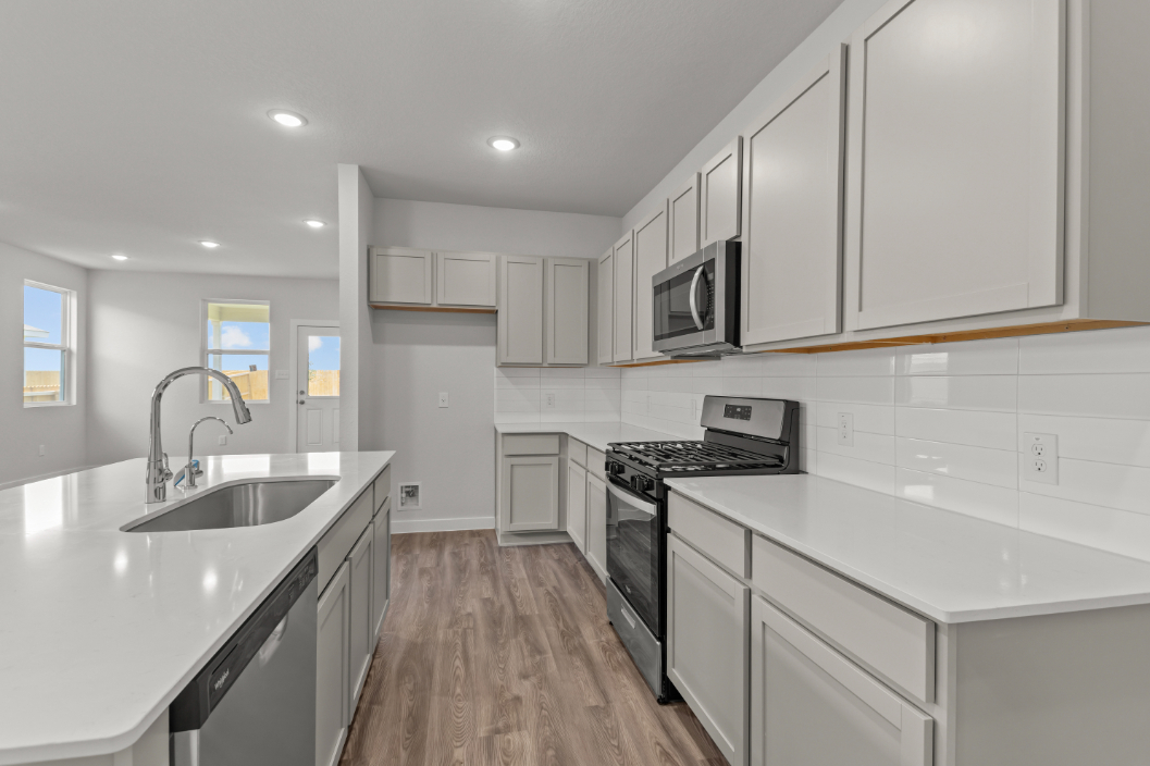 A kitchen with white cabinets.