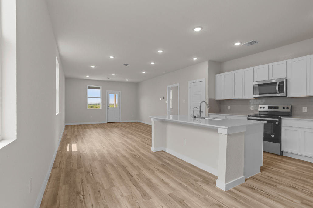 A kitchen with white cabinets.