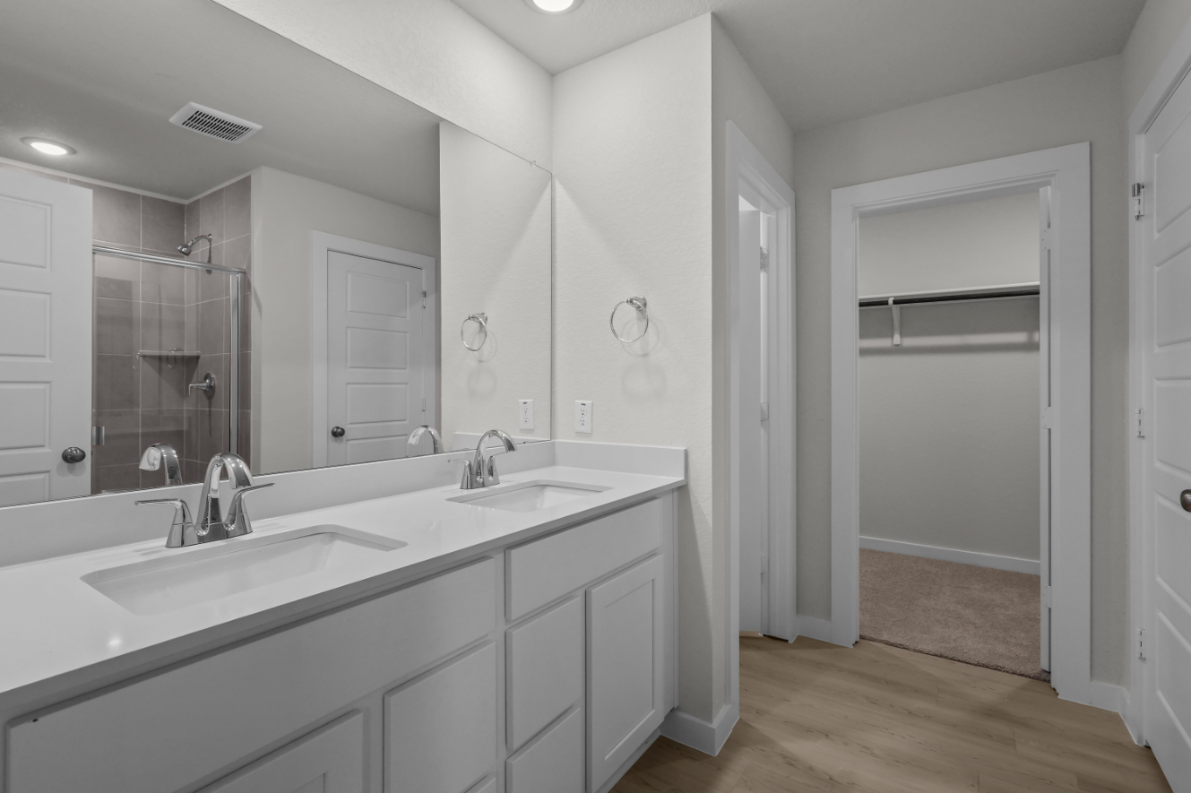 A bathroom with a large mirror.