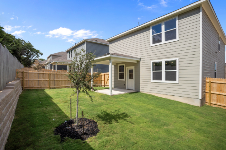 A house with a yard and a fence.