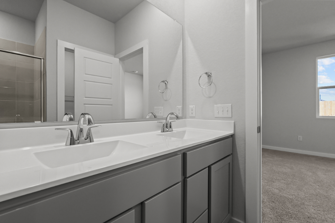 A bathroom with a large mirror.