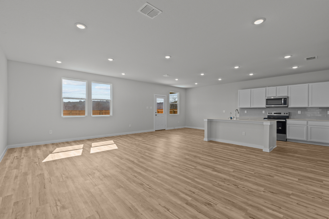 A large kitchen with white cabinets.