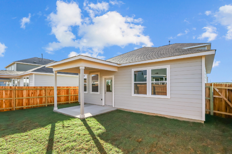 A house with a fence and a lawn.